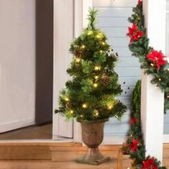 3 Ft. Green Pre-Lit Potted Artificial Christmas Tree With Red Berries And Pine Cones -Northlight Shop pre lit christmas trees m20 8cm674 31 1000